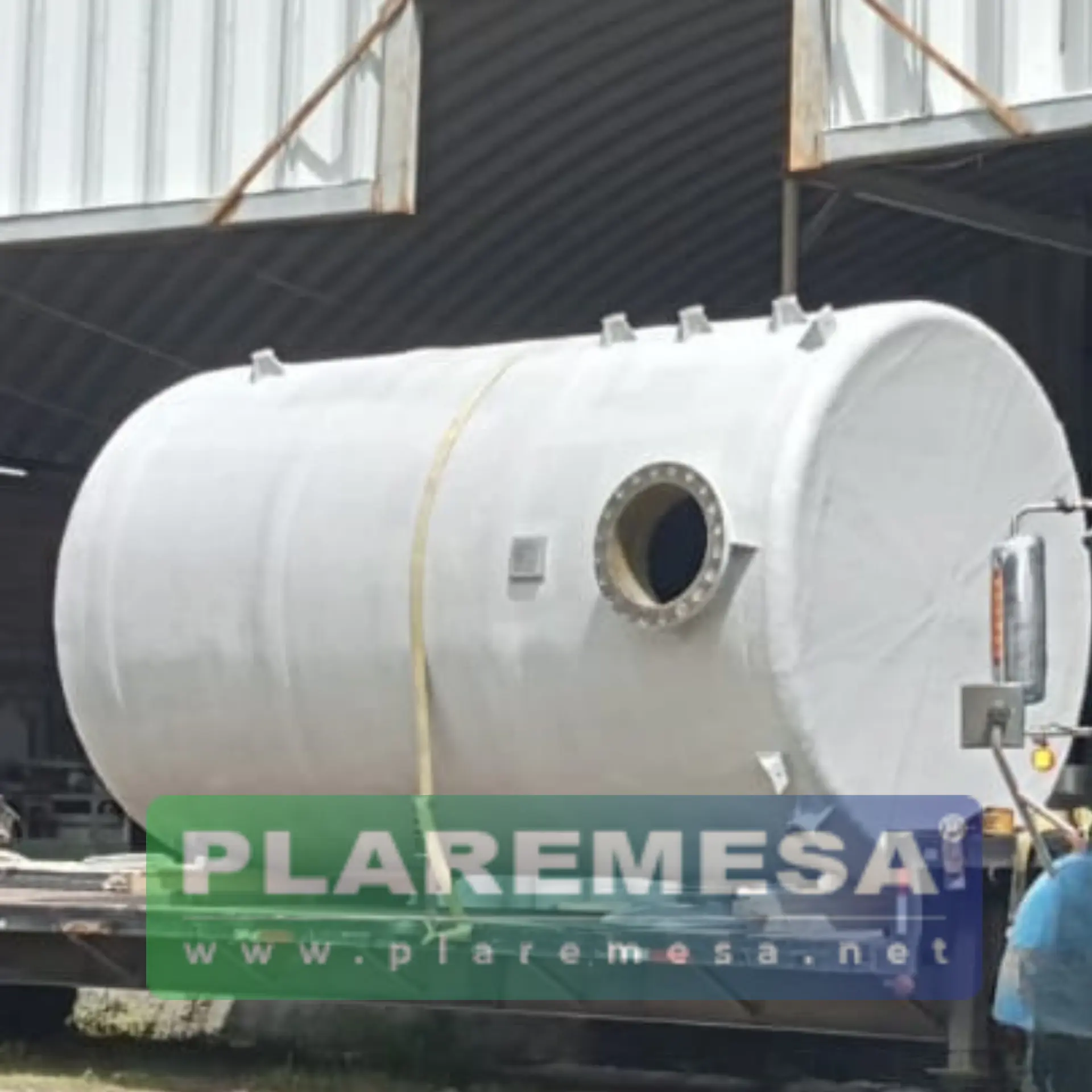 Tanque cilíndrico horizontal de fibra de vidrio sujeto a una plataforma de transporte